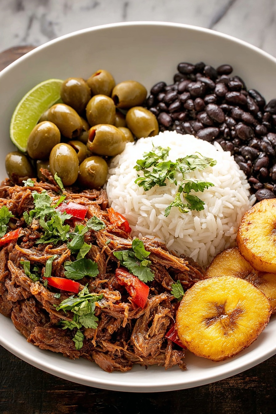 A bowl of Cuban Ropa Vieja with rice and beans.