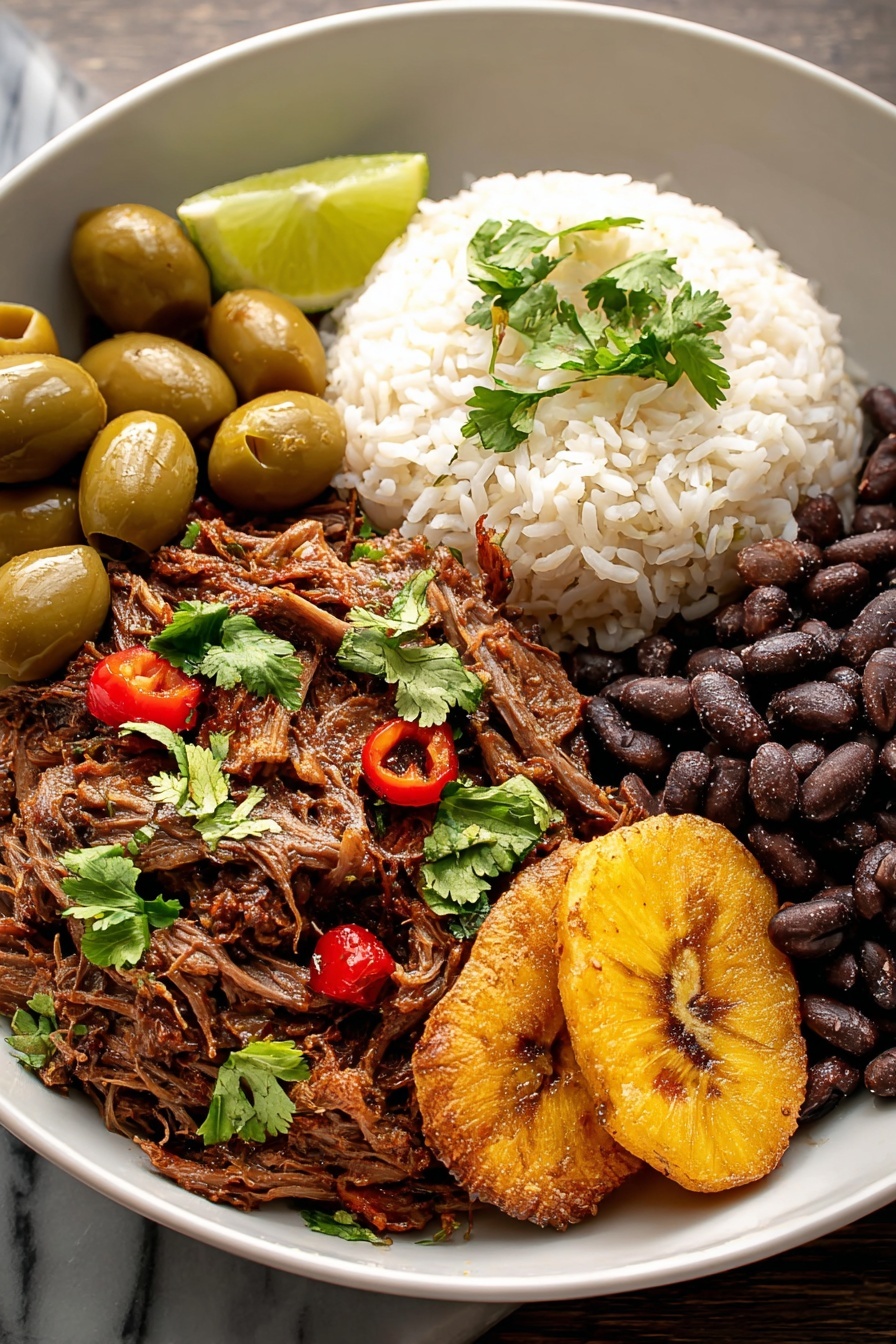 A plate of Cuban Ropa Vieja with rice and beans.