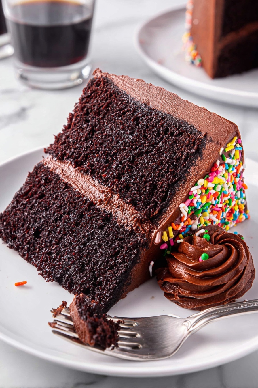 A slice of chocolate cake with sprinkles.