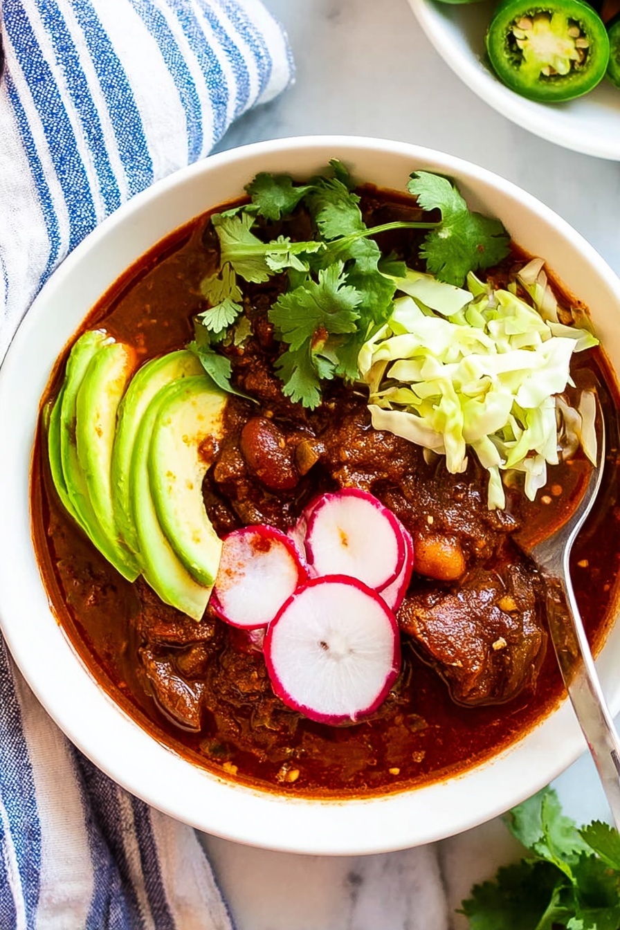 A bowl of Mexican Pozole with a spoon.