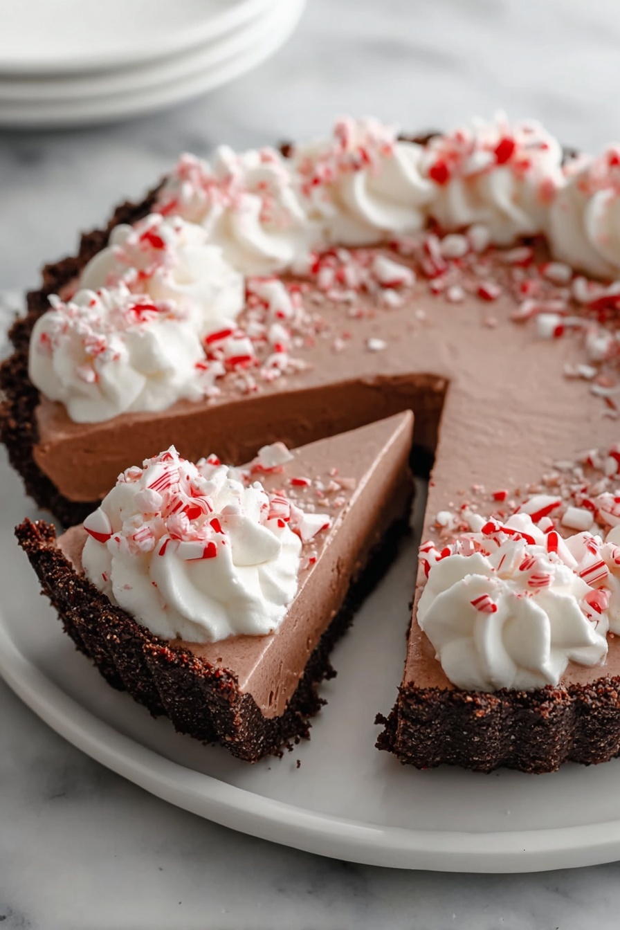 A slice of peppermint pie with white whipped cream.