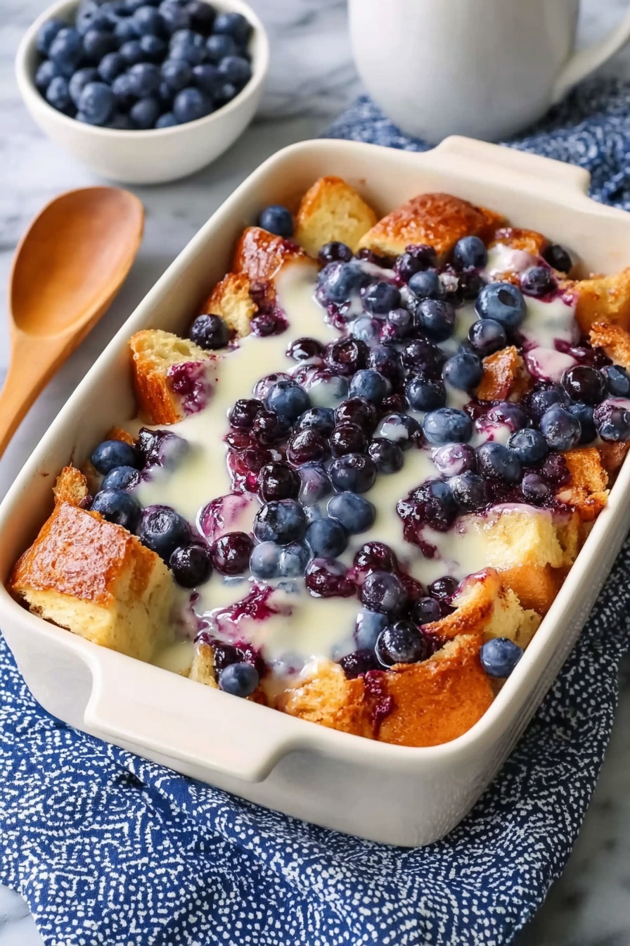 A white bowl filled with a blueberry French toast casserole.
