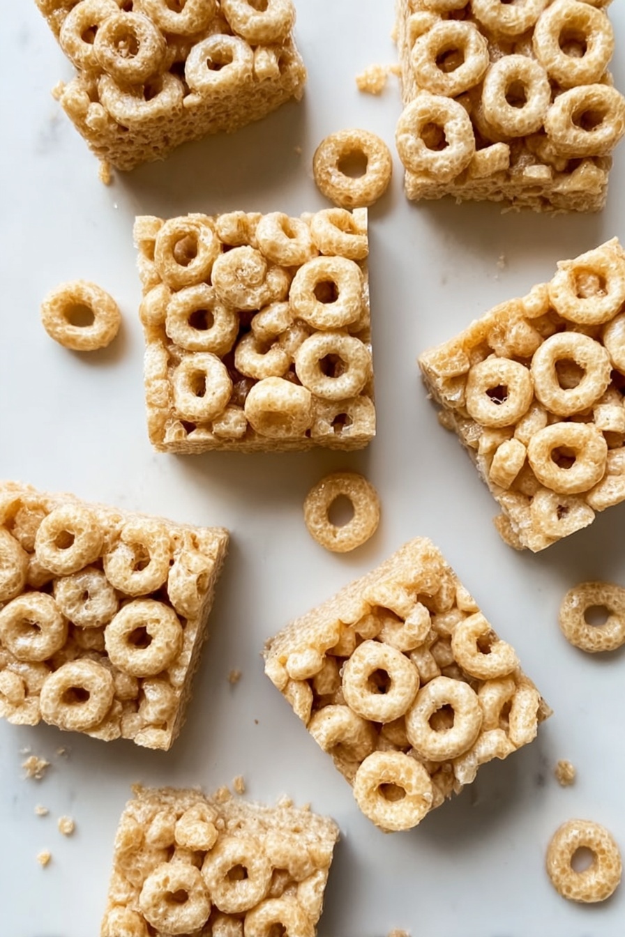 A close up of a square of peanut butter and cheerios.