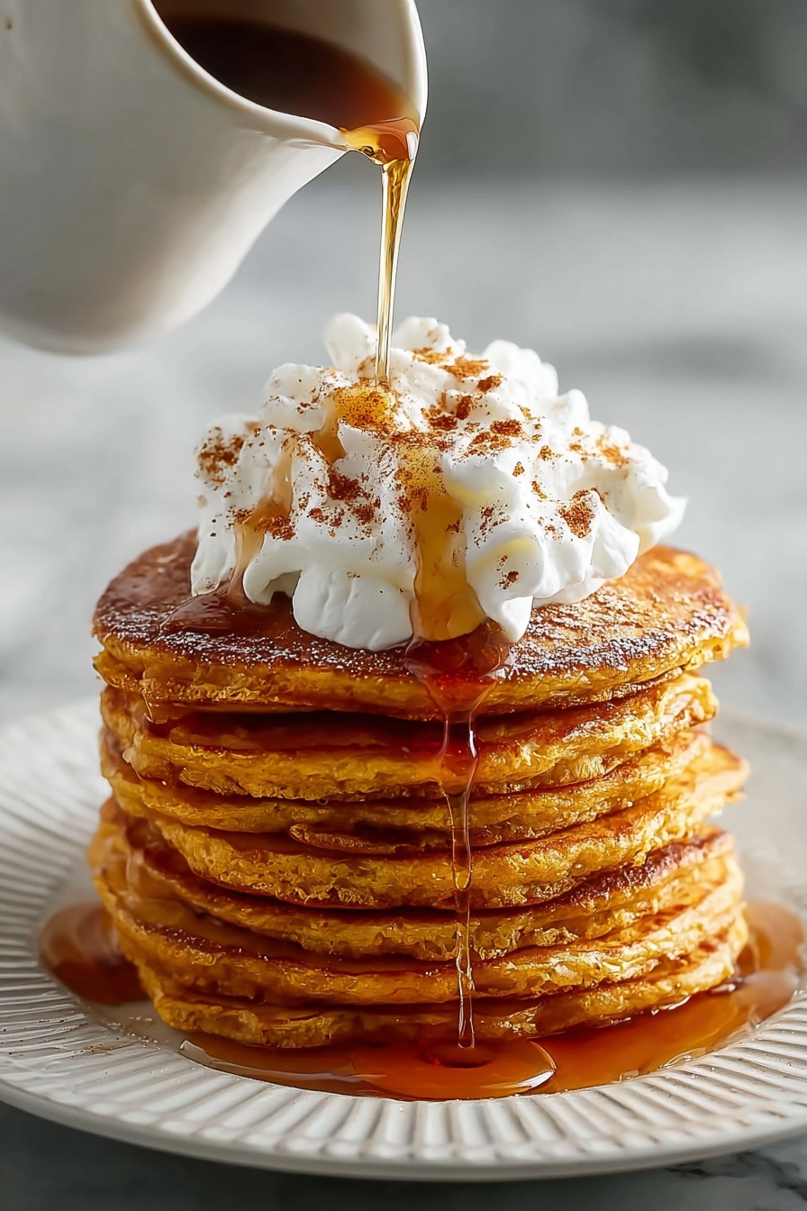 Pumpkin spice pancakes with whipped cream.
