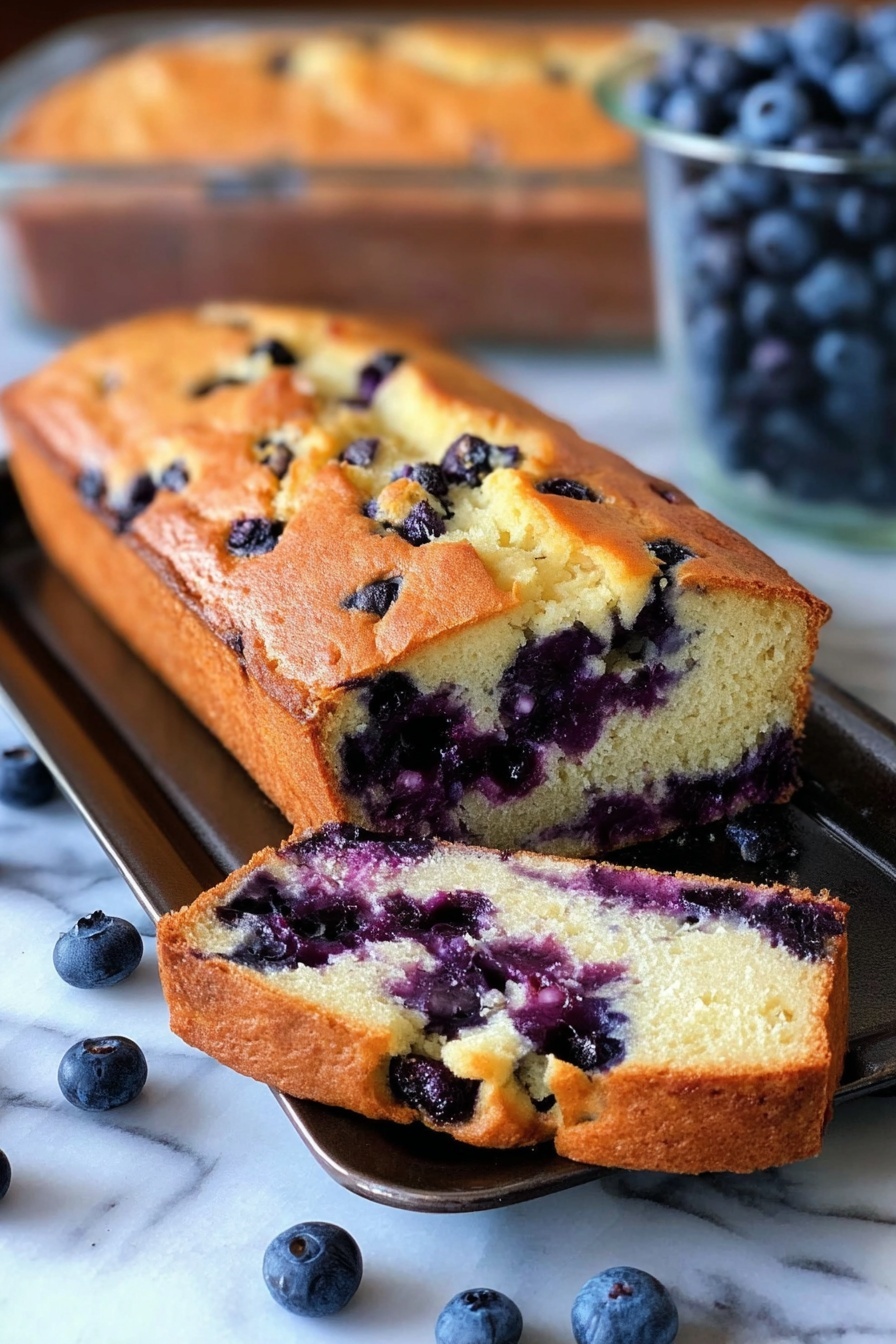 A slice of blueberry cream cheese bread.