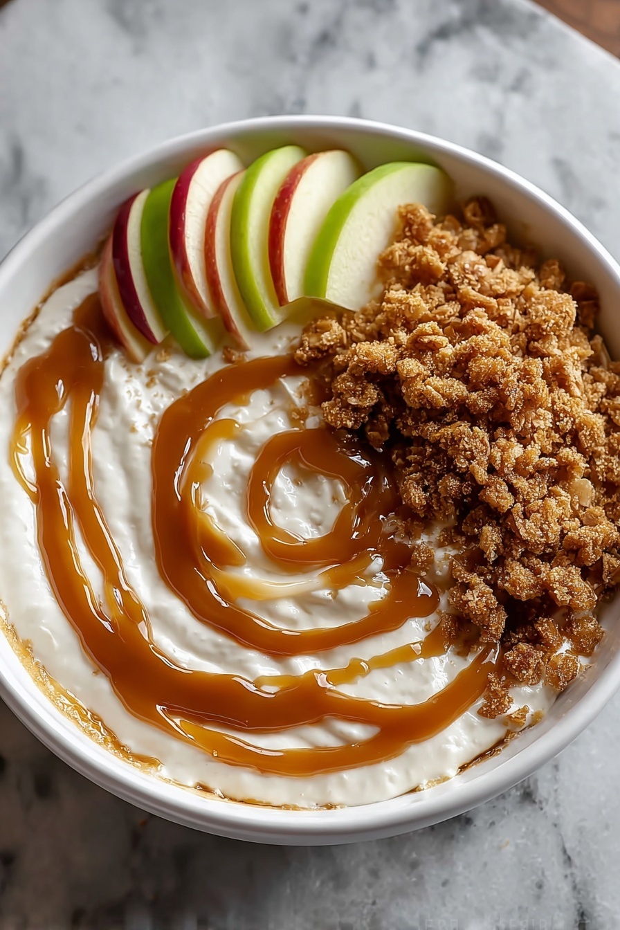 A bowl of caramel apple dip with a spoon in it.