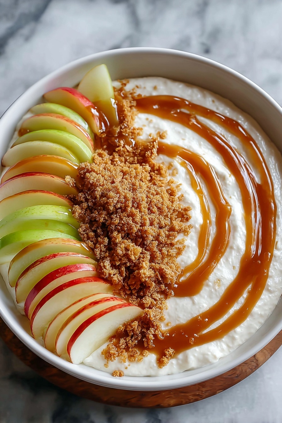 A bowl of caramel apple dip with a spoon in it.