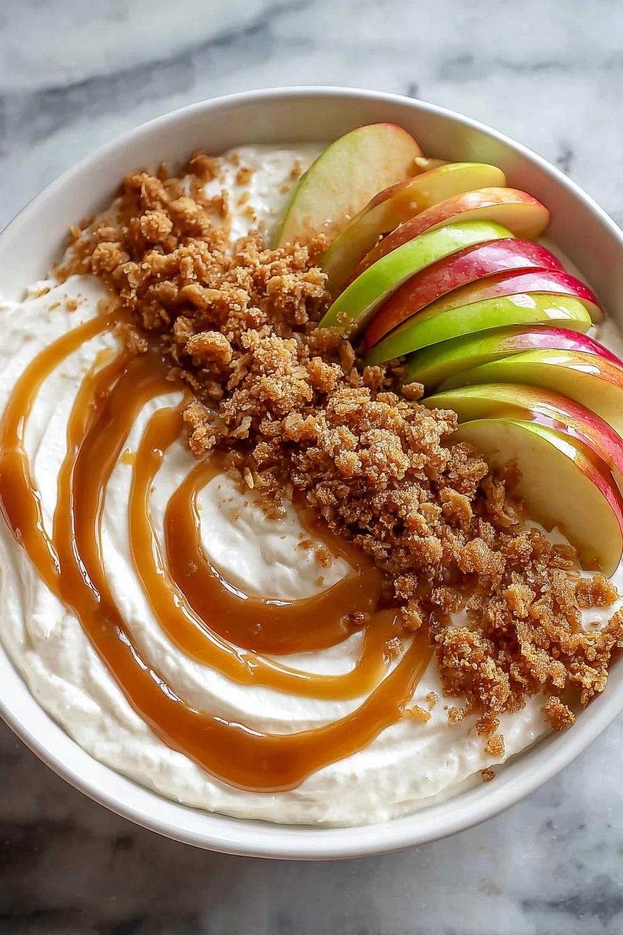 A bowl of caramel apple dip with a spoon in it.