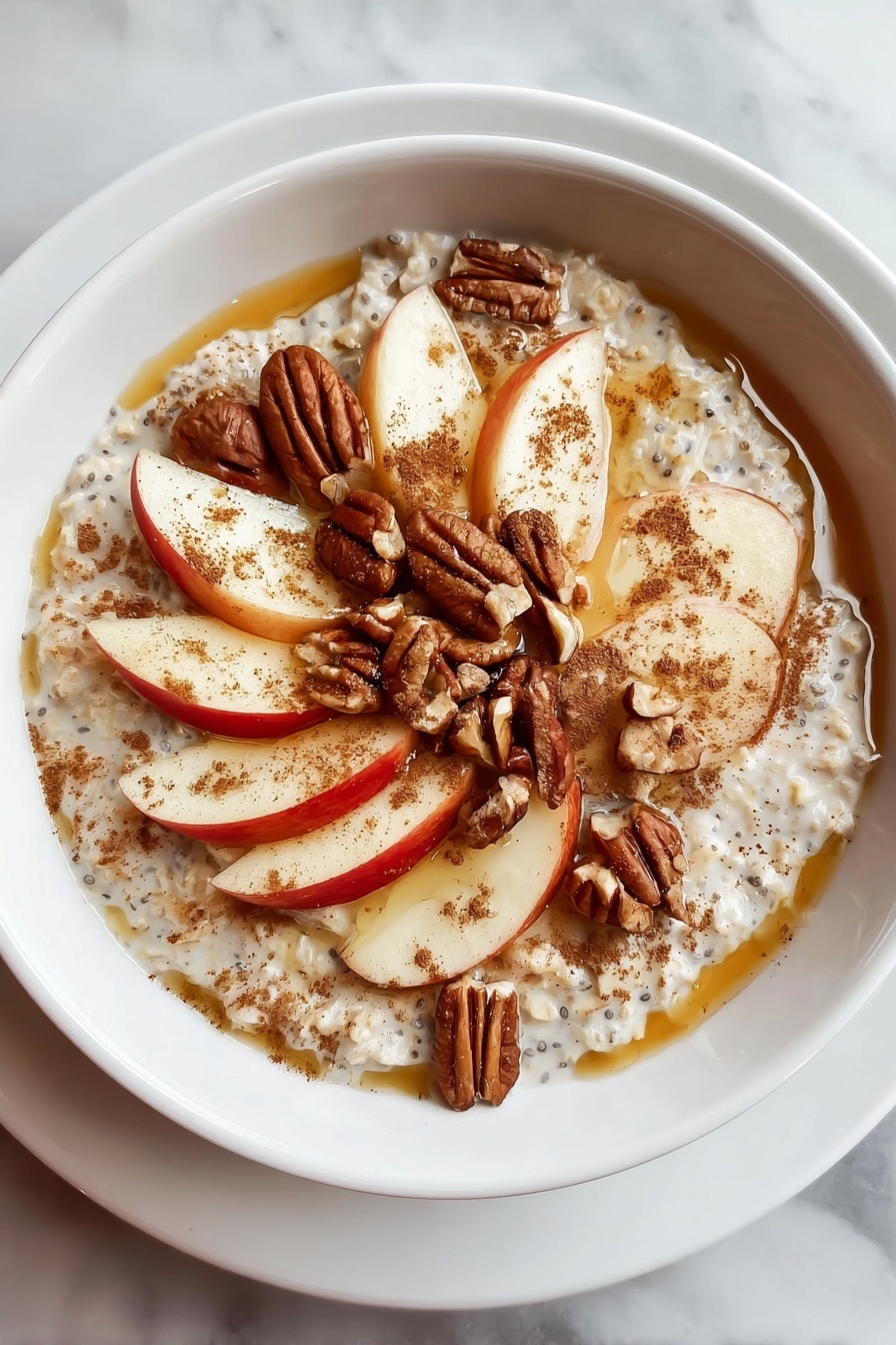 A bowl of oatmeal with apples and nuts.