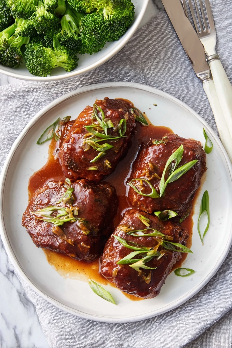 A plate of slow cooker saucy chicken thighs.