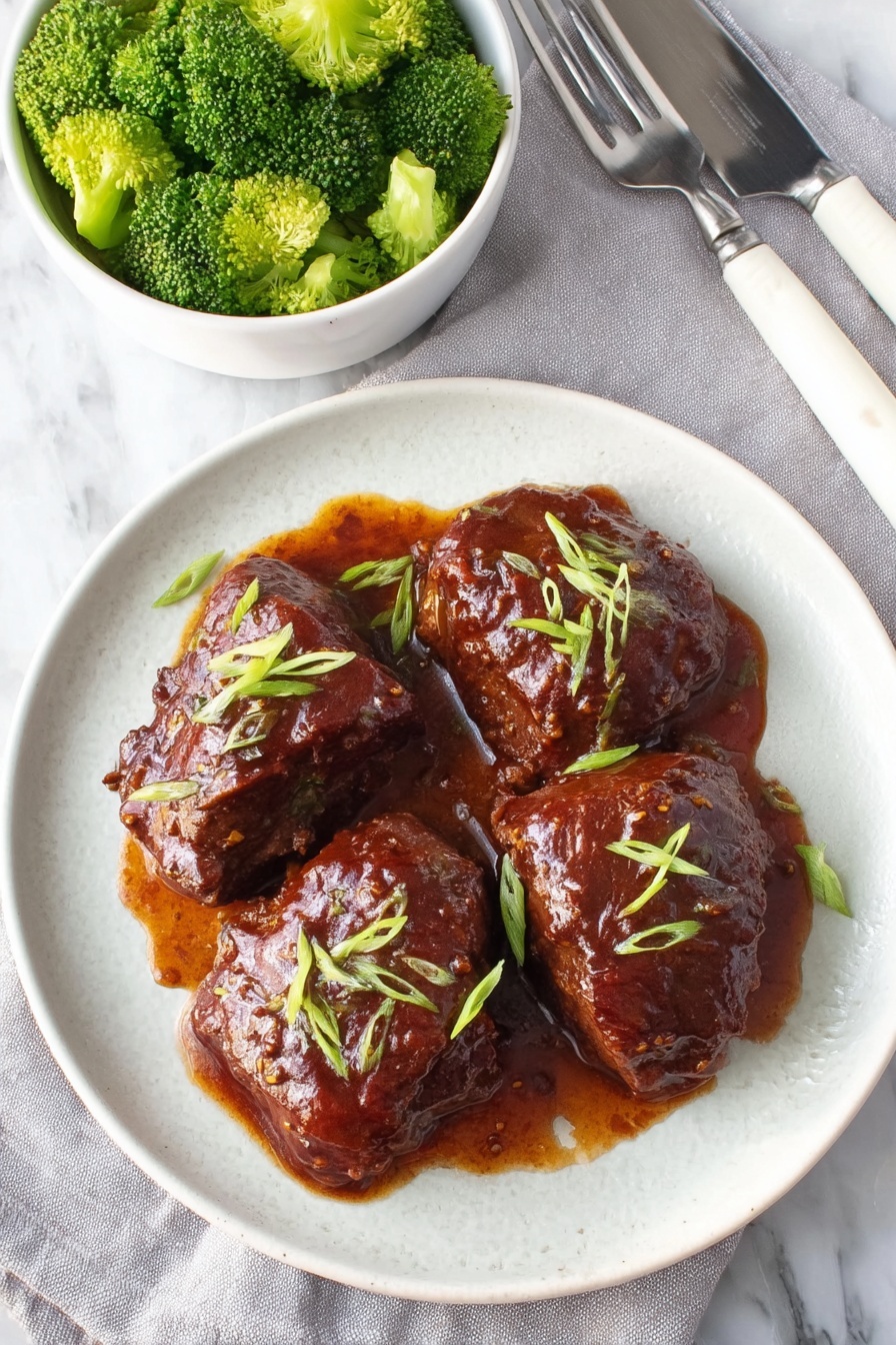 A plate of slow cooker saucy chicken thighs.