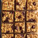A small chunk of chocolate and nuts showing in a square bar.