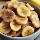 A bowl of sugar coated banana slices.