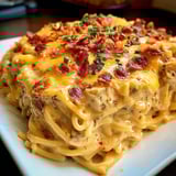 A plate of food with bacon and cheese.