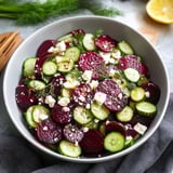 A bowl of vegetables including cucumbers, radishes, and beets.