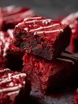Red velvet brownies with white icing.