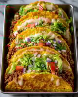 A pan of oven-baked cheesy tacos.