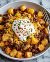 A plate of ground beef and potatoes casserole.