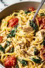 A bowl of creamy tuscan chicken pasta.