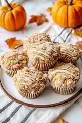 A plate of muffins with a white icing.