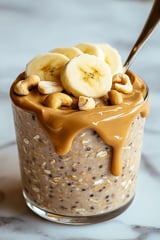 A glass of peanut butter banana oats.