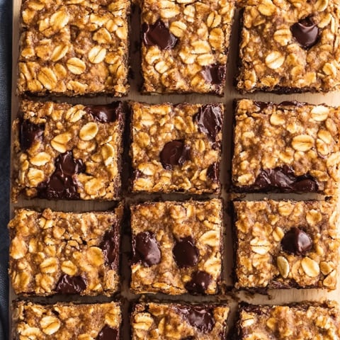 A small chunk of chocolate and nuts showing in a square bar.