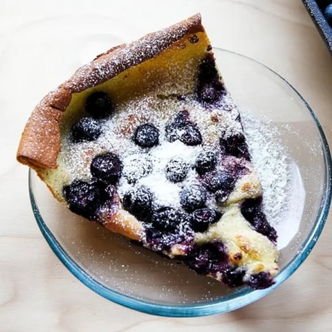A slice of blueberry pie on a plate.
