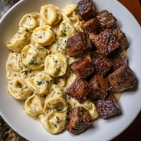 A plate of pasta and meat.
