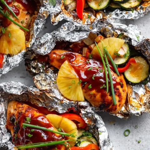 Juicy chicken with pineapple chunks and bright veggies up close.