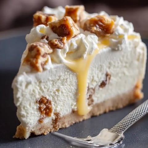 A slice of cheesecake with lots of caramel on top.