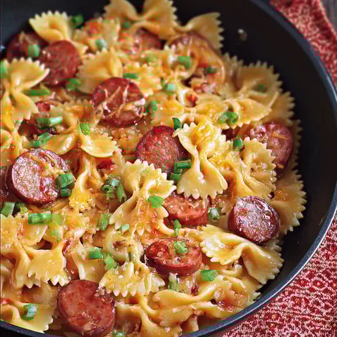 Bowl filled with pasta, sausage, and veggies.