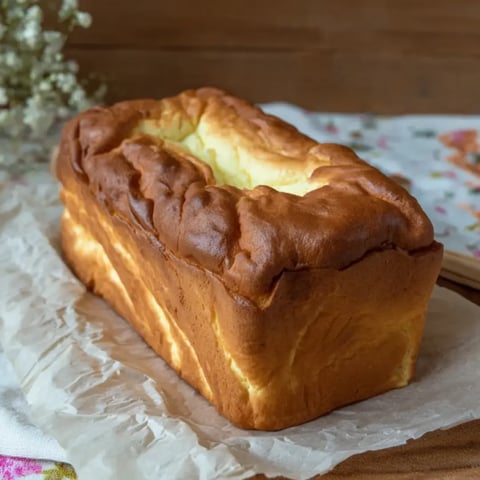 Bread loaf with a big hole in the middle sitting on a counter.