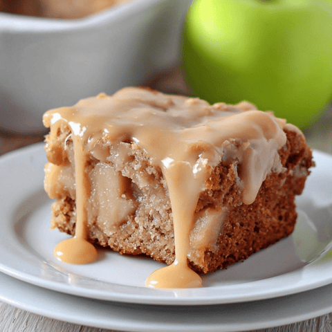 A slice of moist cake covered with a caramel drizzle on top.