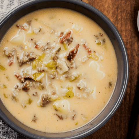 Meaty soup with veggies in a bowl, ready to eat.