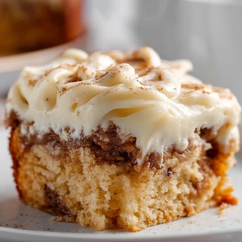 A slice of cake with white frosting.