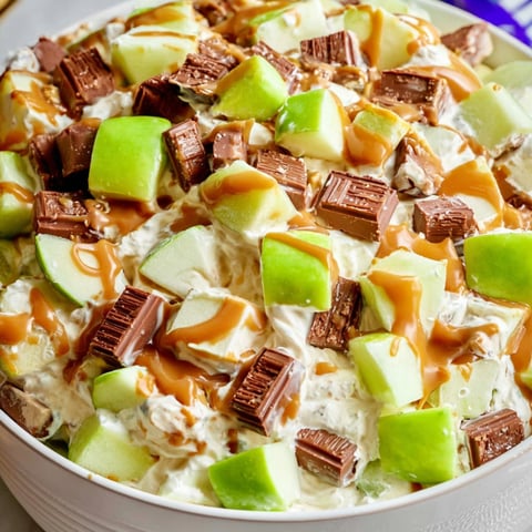 Bowl packed with apples, chocolate, and caramel drizzle.