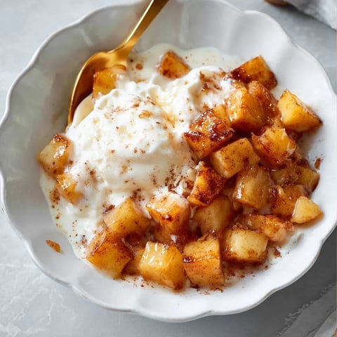 A bowl of treats with a spoon inside.