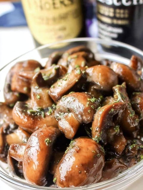 A bowl of mushrooms with butter and Worcestershire sauce.