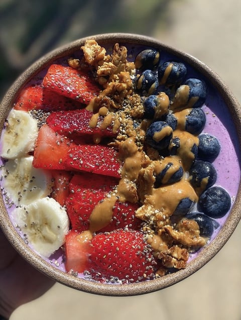 A bowl of fruit and nuts.