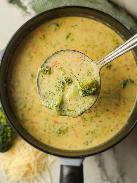 A spoon is in a bowl of soup.