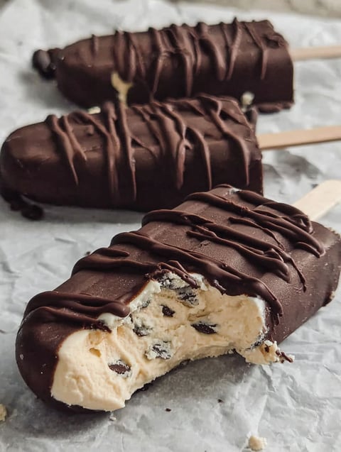 A close up of a chocolate and white frozen treat.
