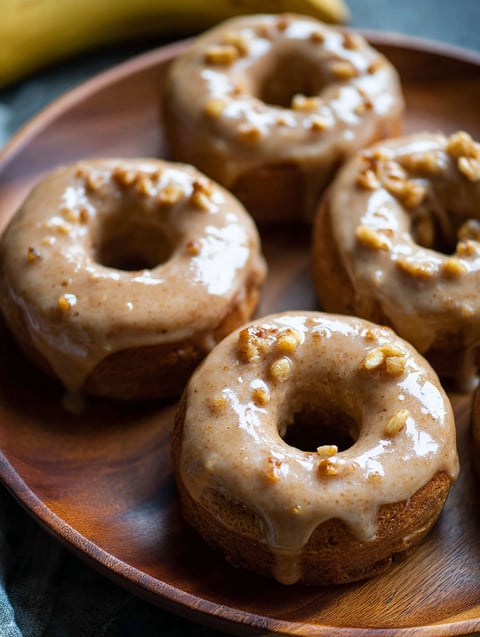A plate of banana bread donuts.