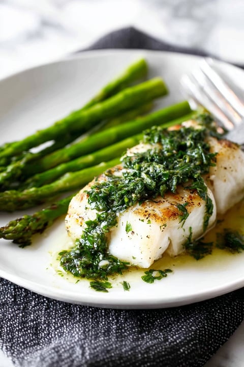 A plate of grilled fish with lemon butter.
