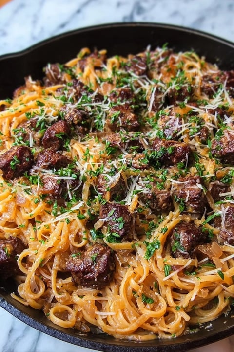 A dish of creamy beef garlic butter pasta.