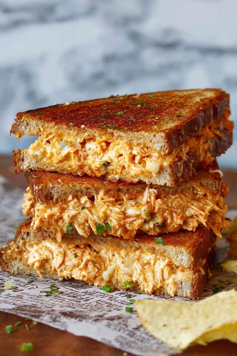 A stack of three hot and cheesy chicken melts.