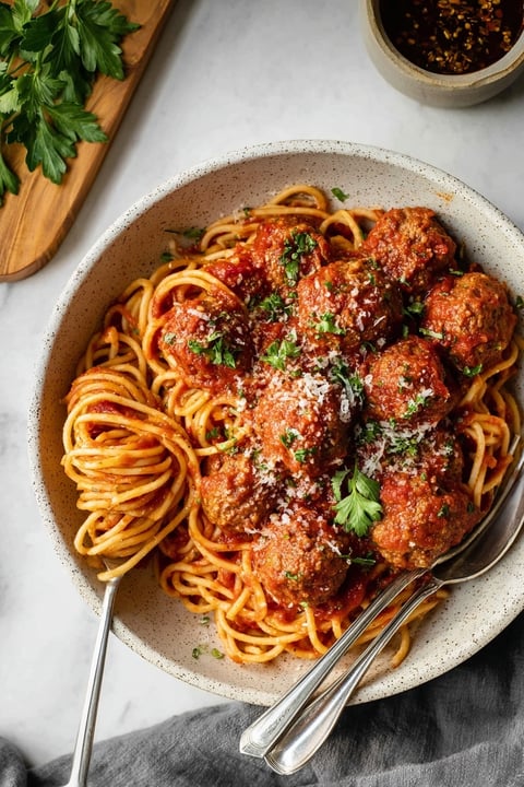 A bowl of spaghetti with meatballs.
